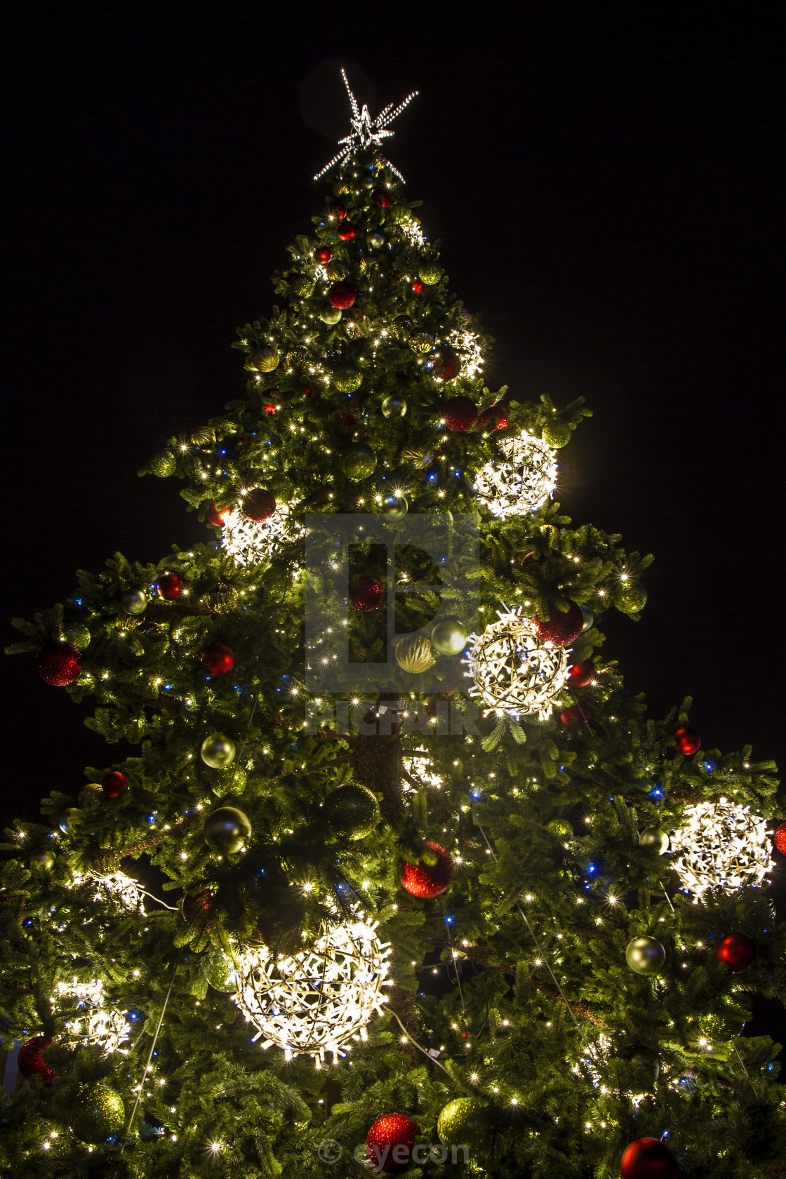 Christmas tree with decoration on black background - License ...