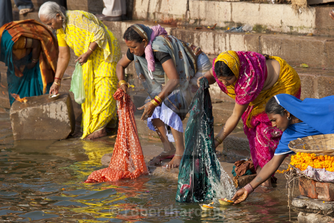 Indian Hindu Pilgrims Washing Clothes And Bathing In The Ganges