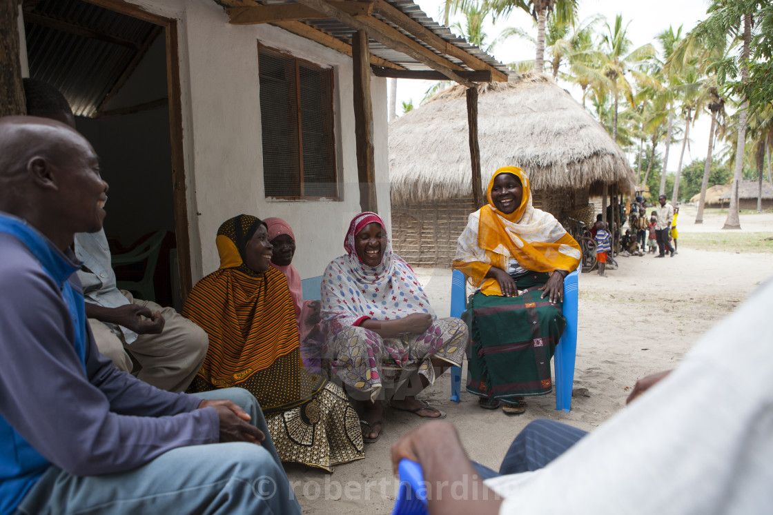 "A group of women involved in a meeting about their village." stock image