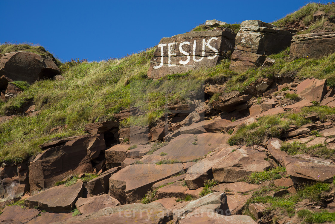 "jesus written large on st bees head" stock image