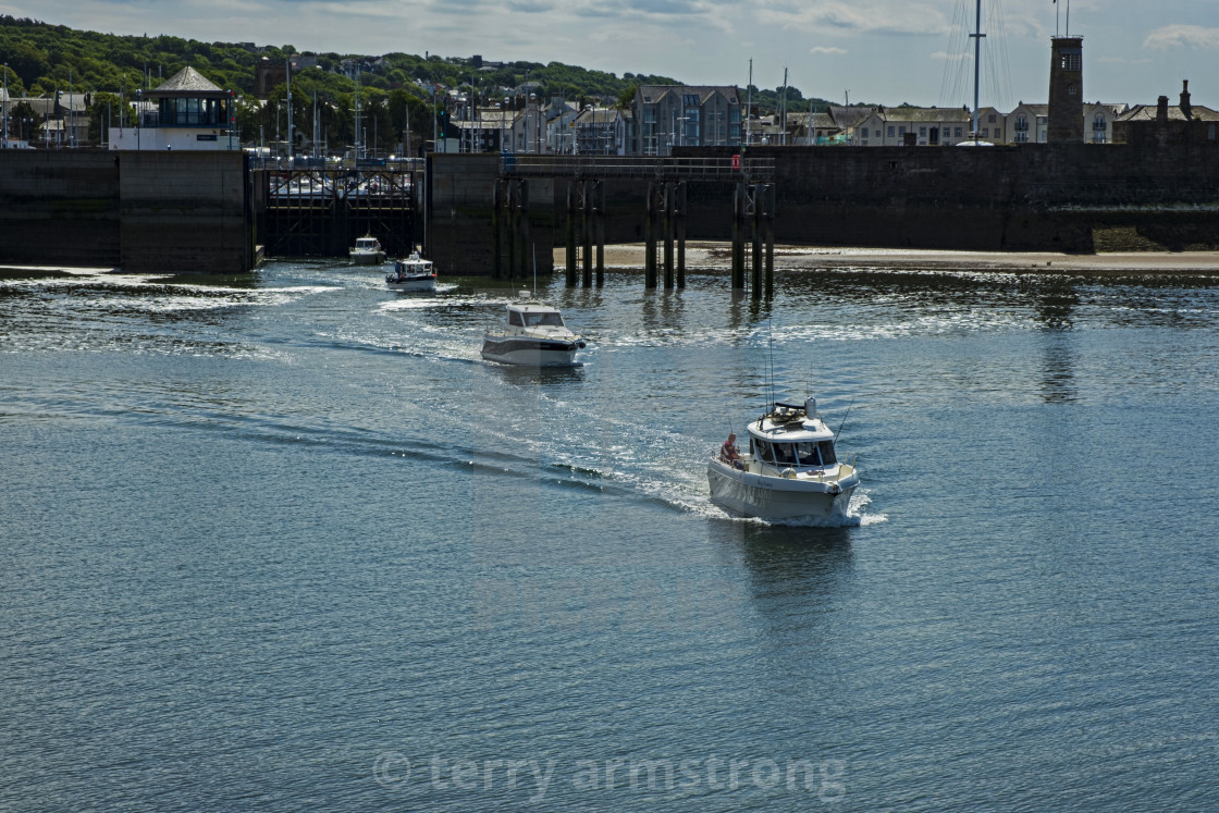 "boats leaving whitehaven harbour" stock image