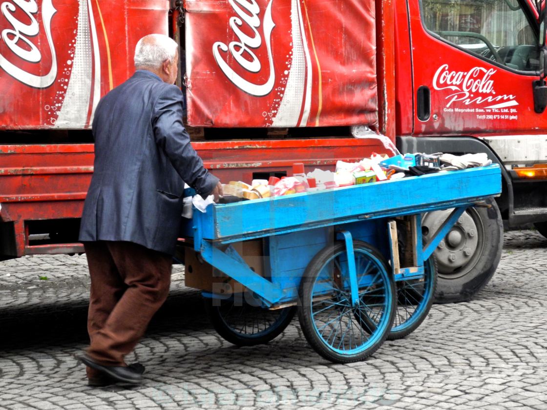 "Venditore ambulante e multinazionale" by turzo almerindo - $3.06 "Venditore ambulante e multinazionale" stock image