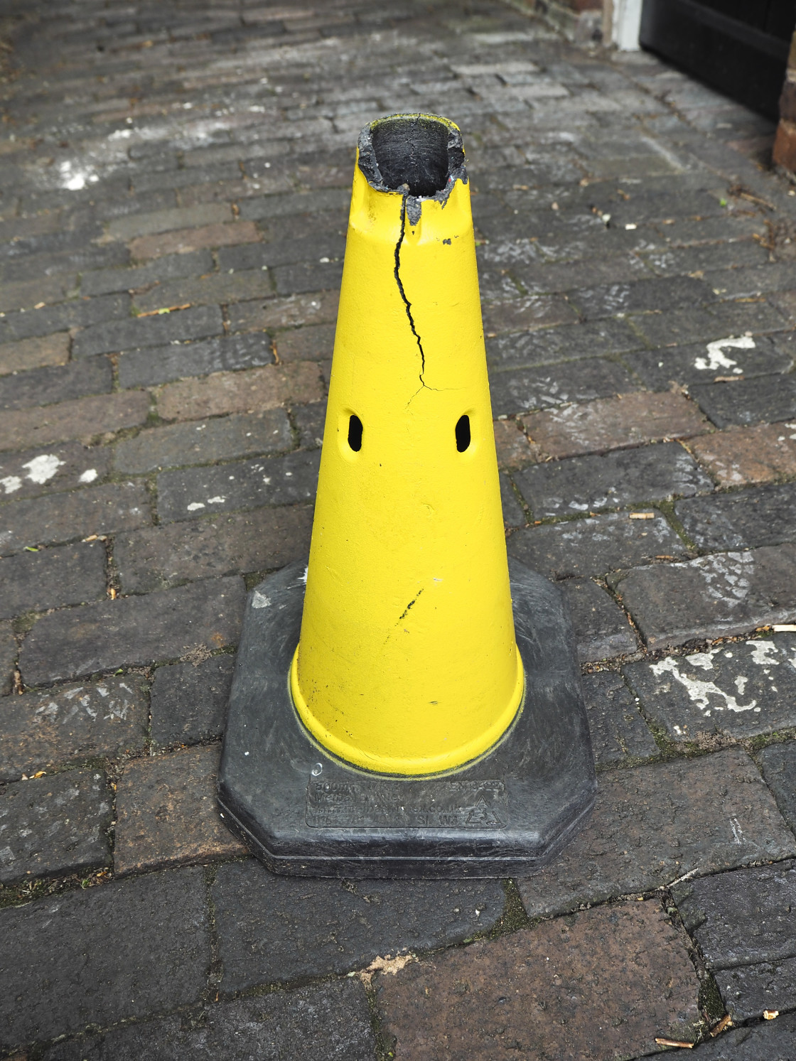 "A yellow traffic cone that looks like a face" stock image