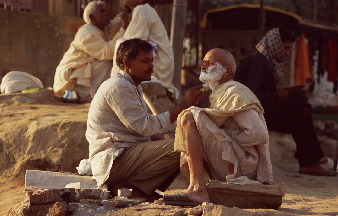 "Man getting haircut and shave, Varanasi, India" stock image