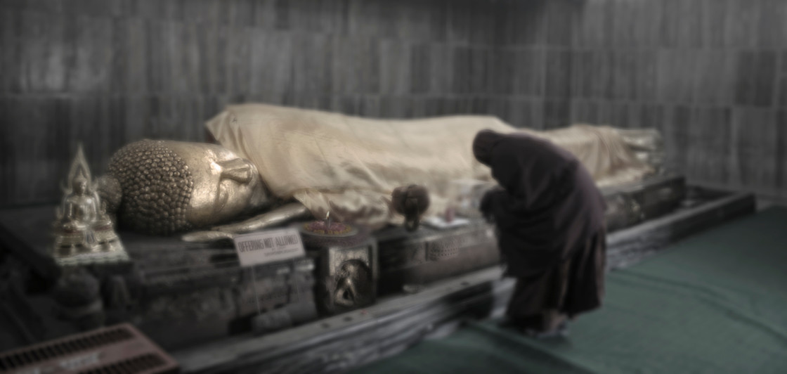 "monk with reclining Buddha, Kushinigar India" stock image