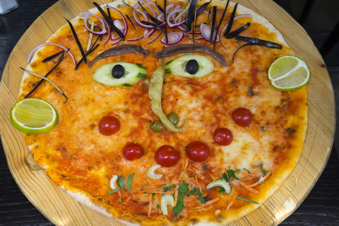 "Pizza with face" stock image