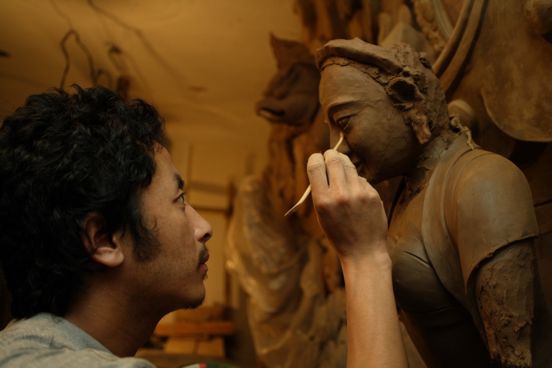 "Artist painting eyes on a statue" stock image