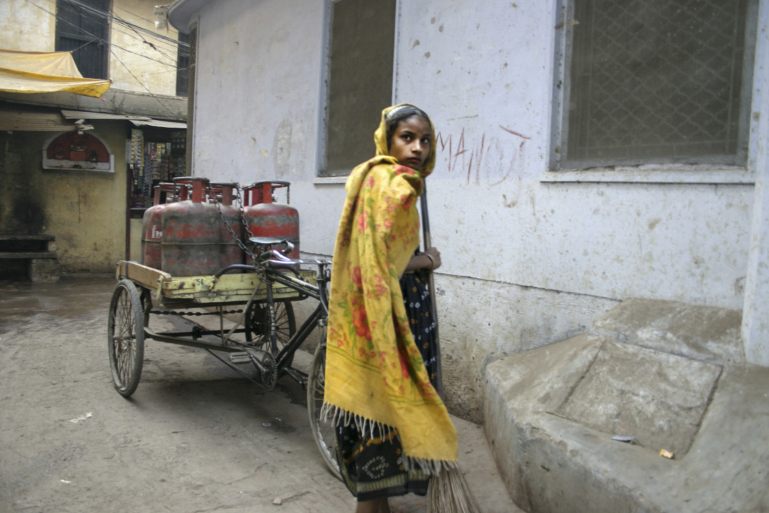 "Young girl with yellow shawl, Varanasi, India" stock image