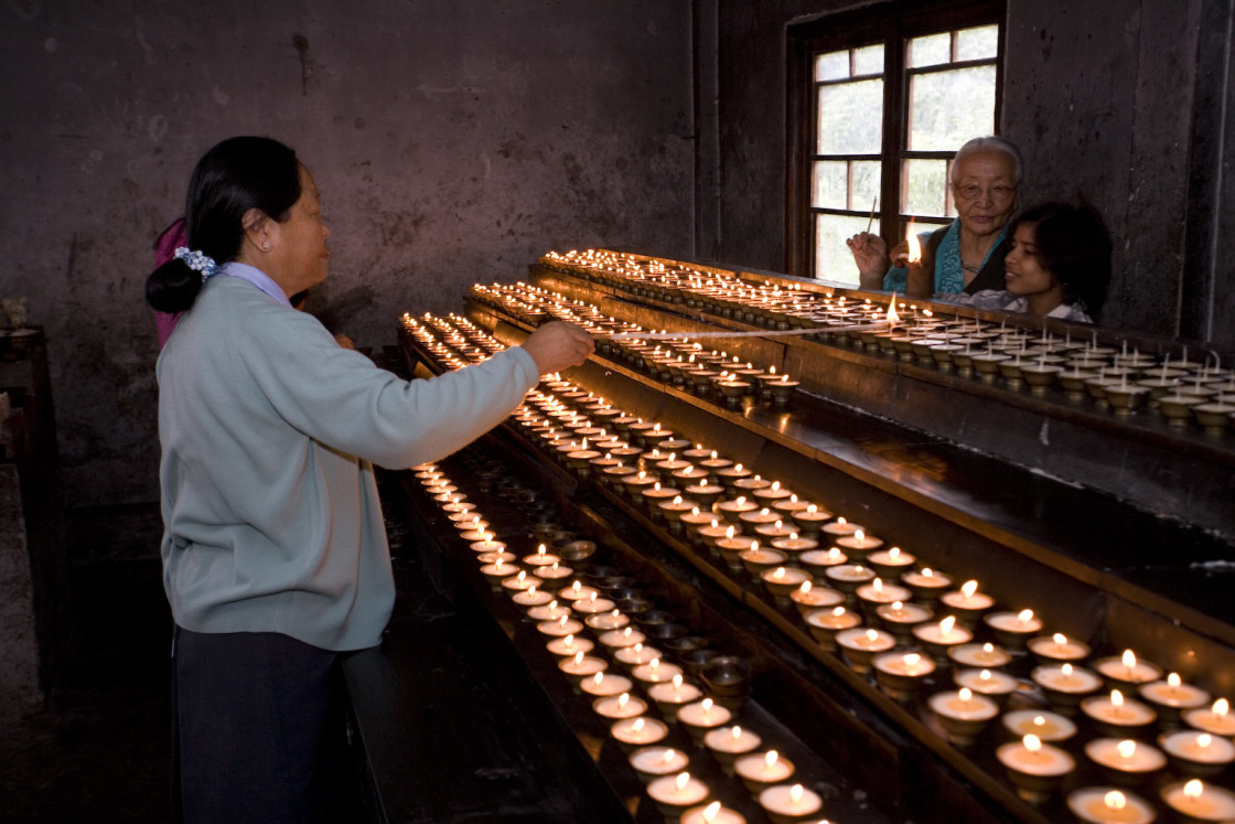 "women lighting candles, Ladakh" stock image