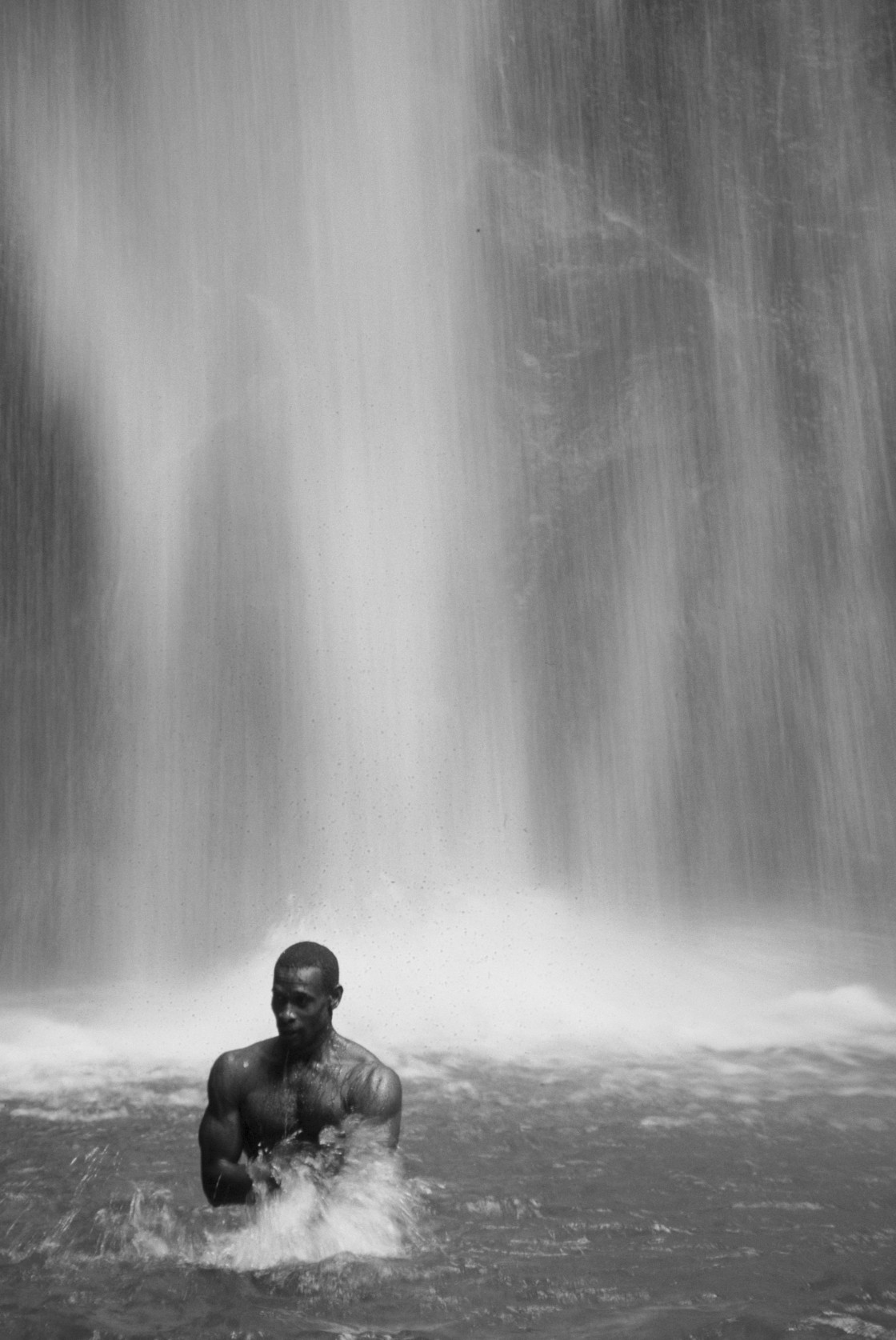 "Man in front of waterfall, Dominica" stock image