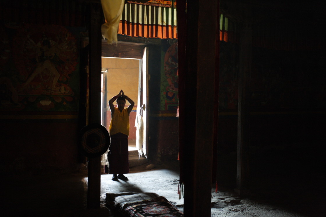 "Monk prostrating in temple doorway, Ladakh, India" stock image