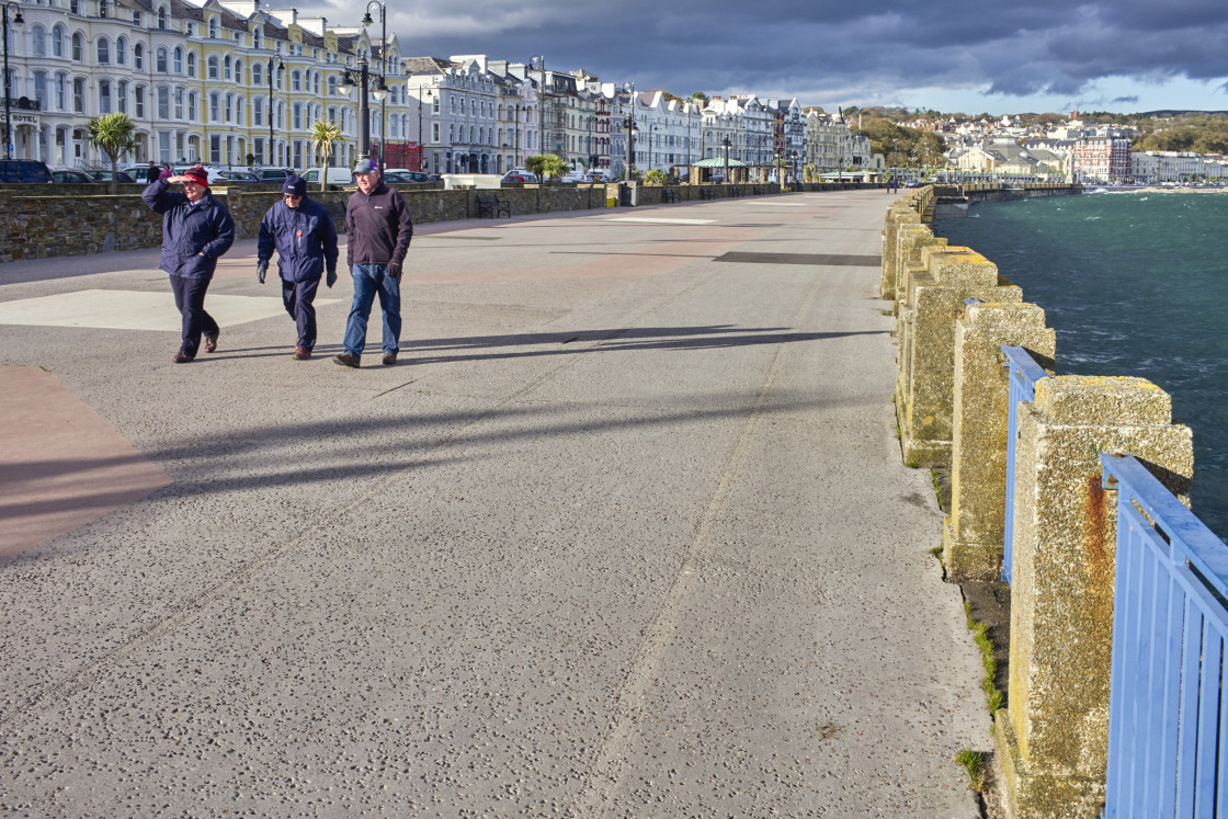 "Three older men walking on Douglas prom" stock image