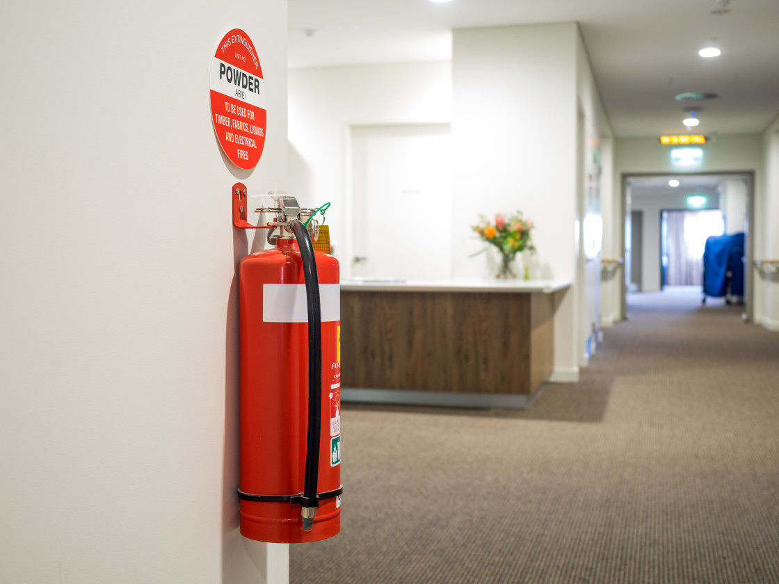 "Fire extinguisher in corridor" stock image