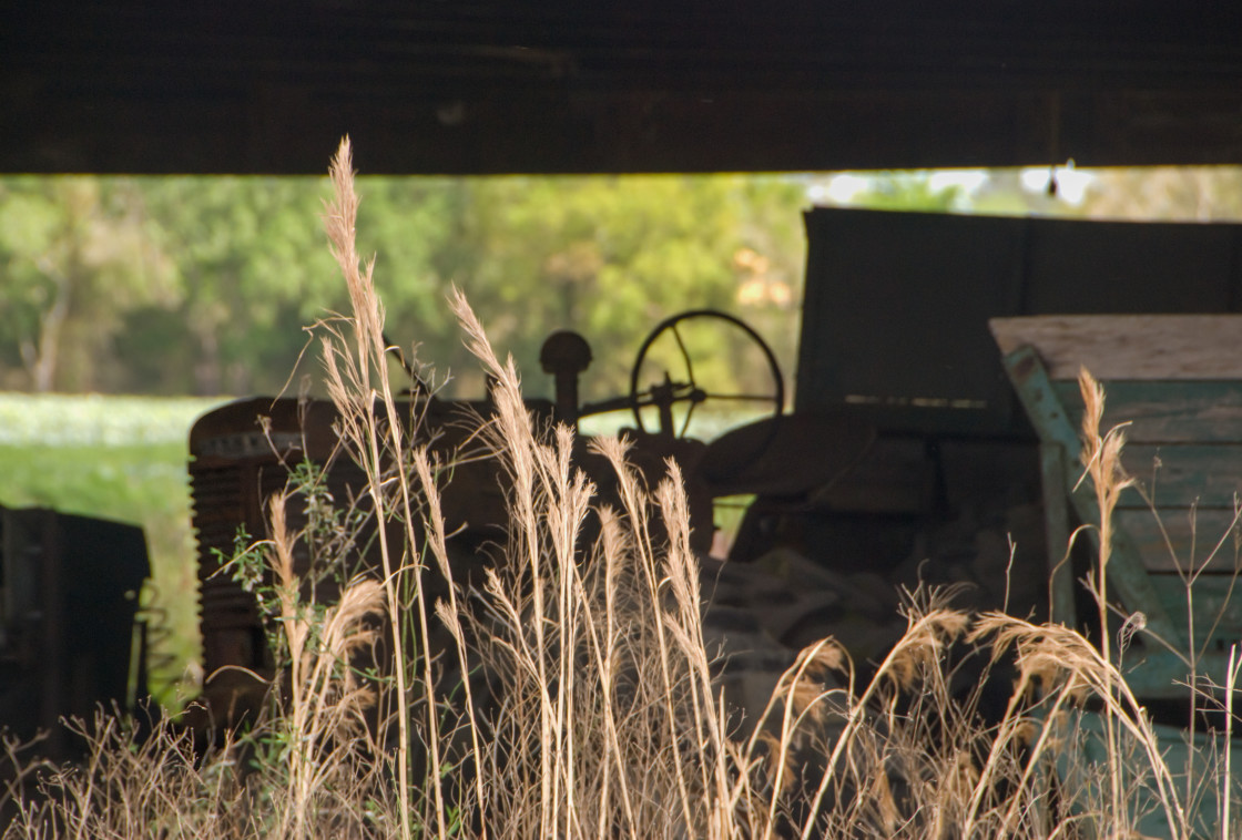 "Old tractor in a barn" stock image