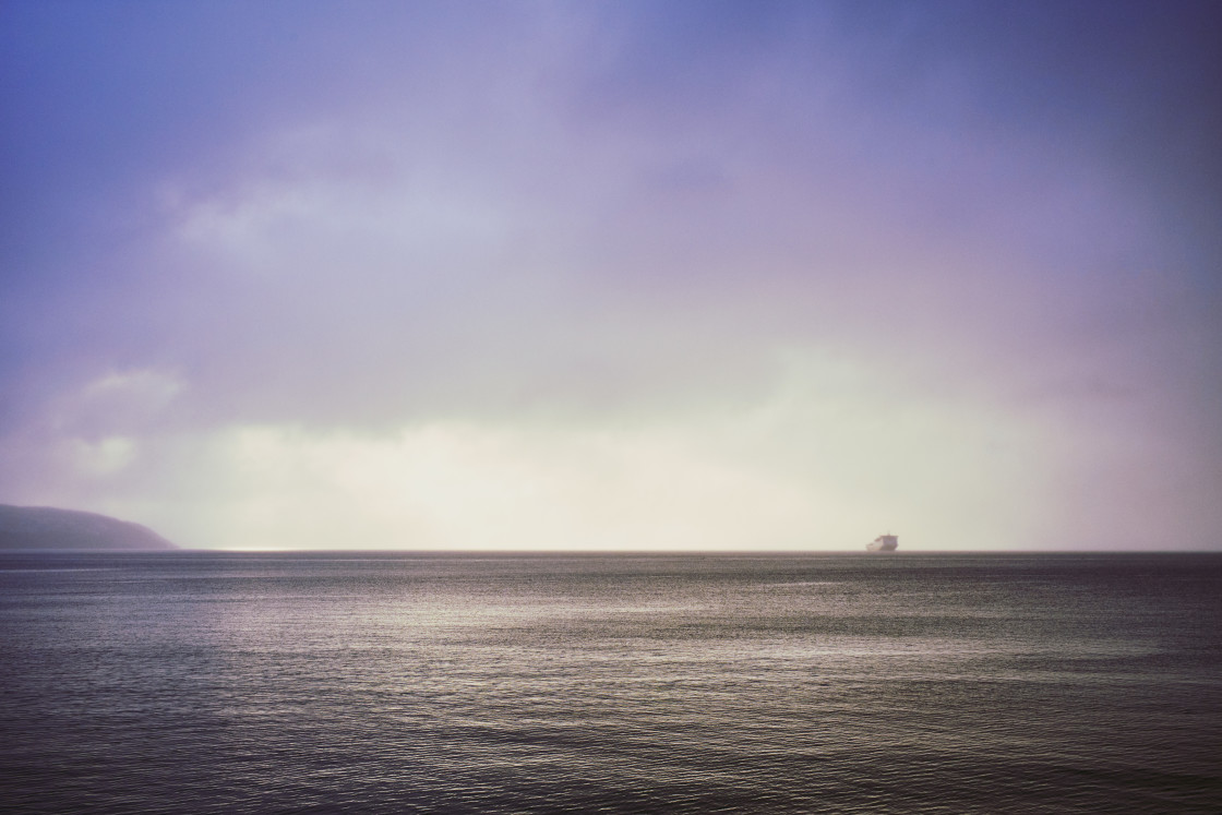 "The ferry crept out of the dawn mist to the the secret isle" stock image