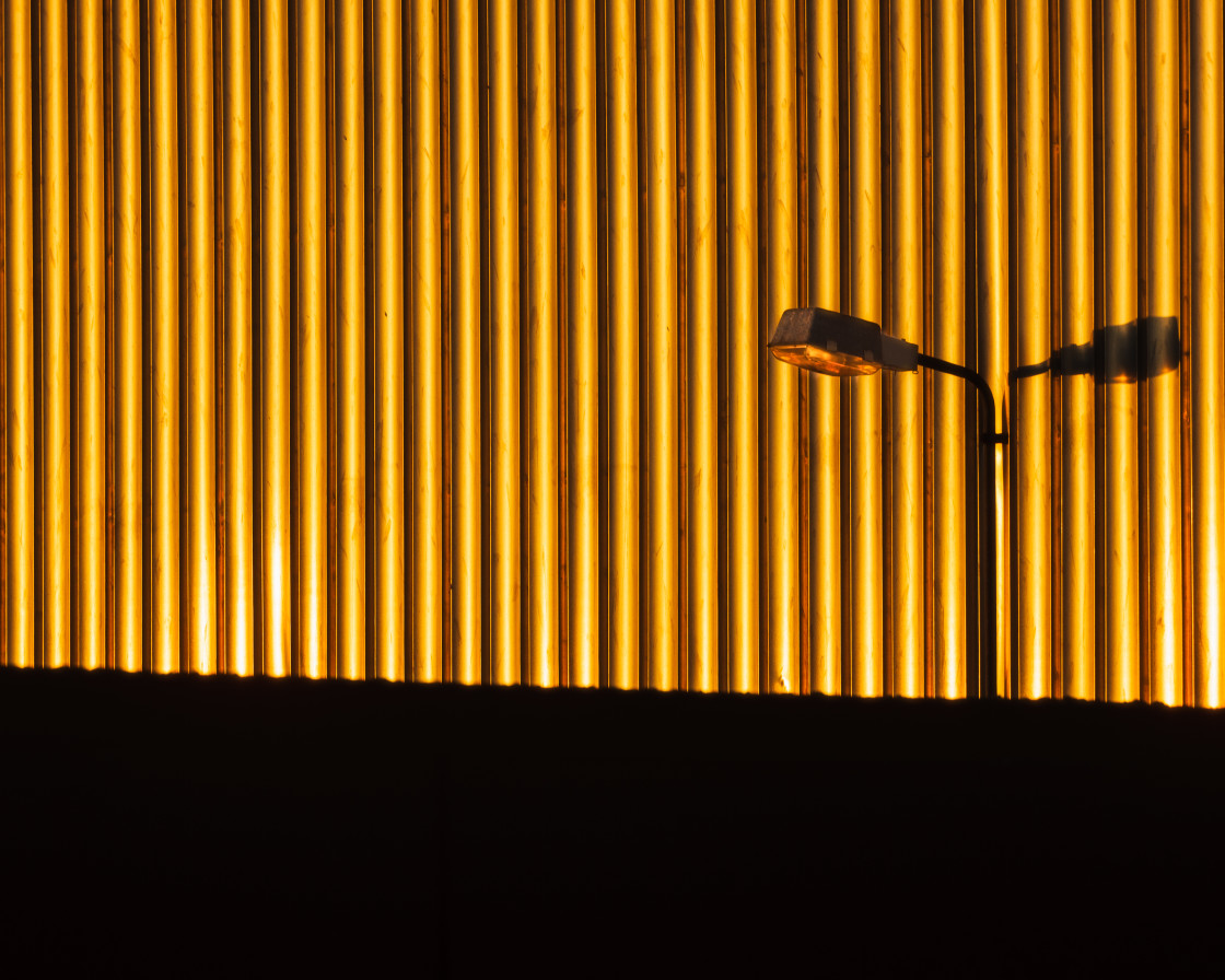 "Street lamp against sunlit wall." stock image