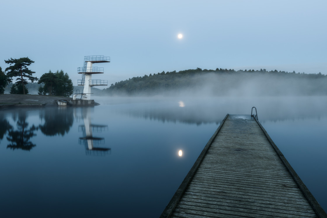 "Dock and diving boards on a misty lake at night. Sweden." stock image