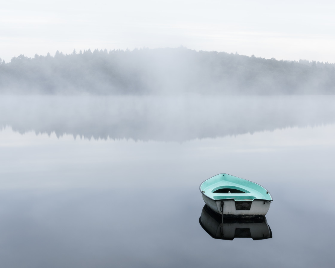 "Rowboat on a smooth, misty lake. Sweden." stock image