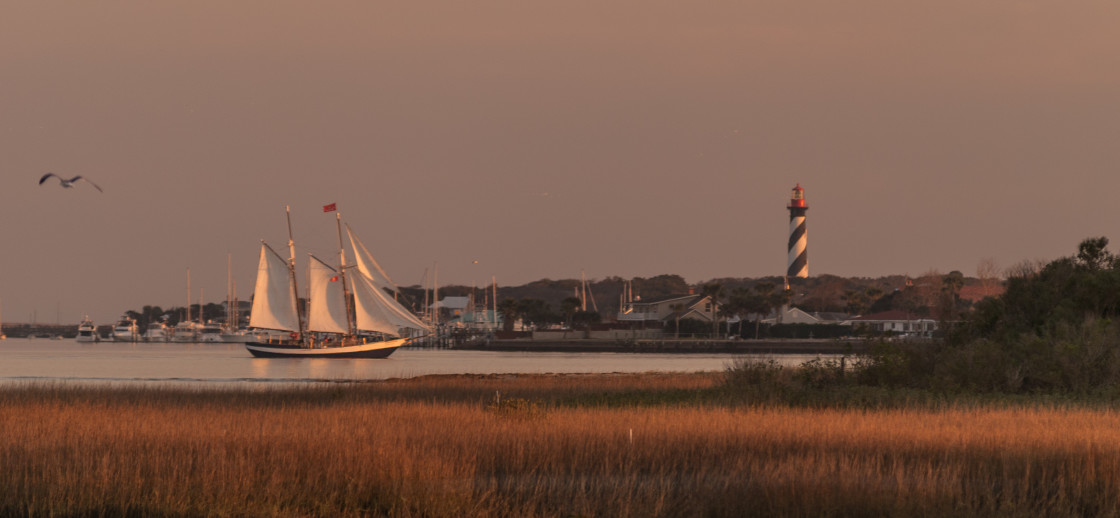 "Sailboat and lighthouse" stock image