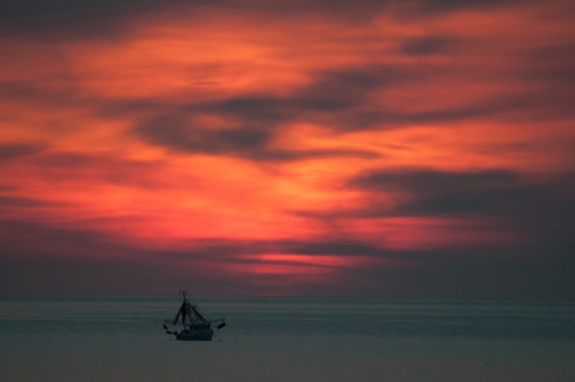 "Shrimp boat at dawn," stock image