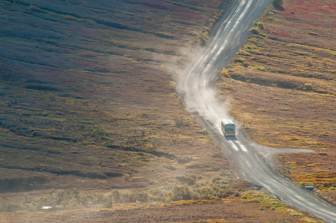 "Bus on a dusty dirt road" stock image