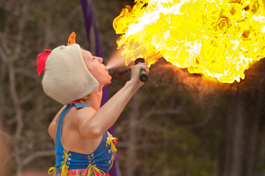 "Circus performer blowing fire" stock image