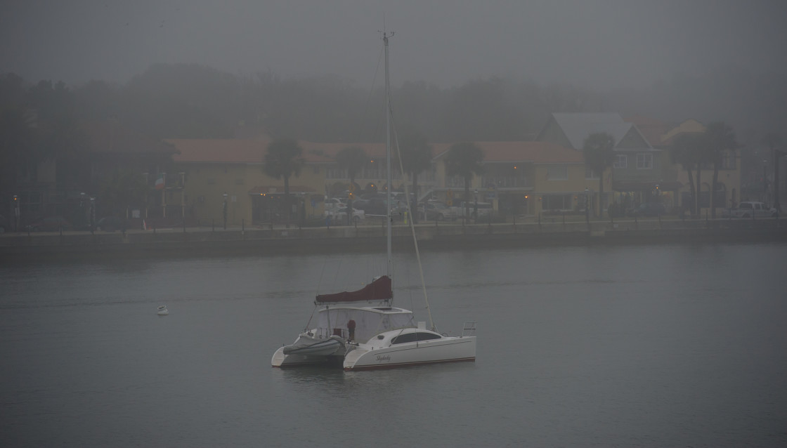 "Sailboat moored in the fog" stock image