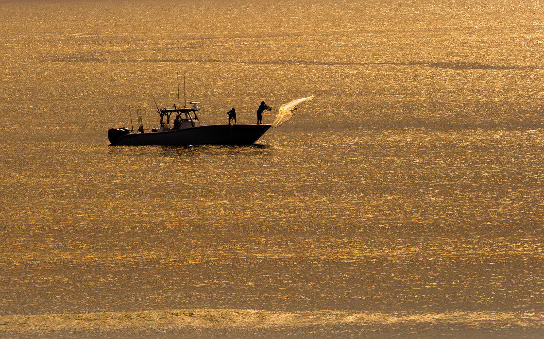 "Casting a net at sunrise" stock image