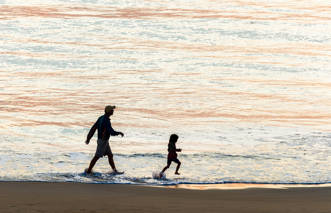 "Father and daughter walking at the beach" stock image