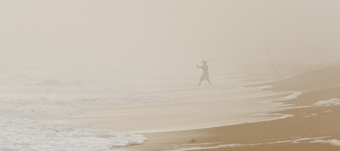 "Surf fisherman in the fog" stock image