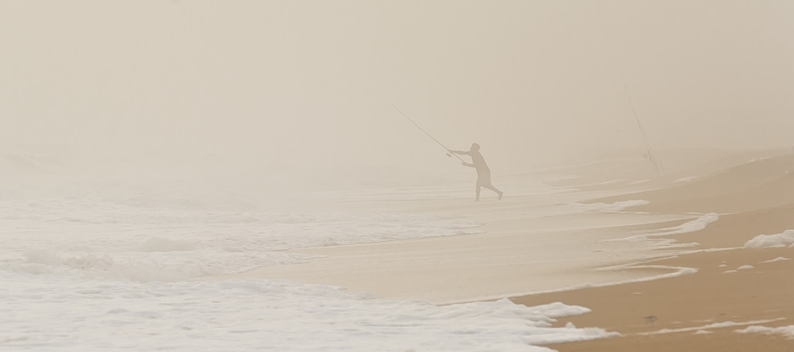 "Surf fisherman in the fog" stock image