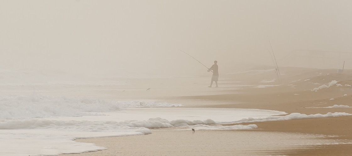 "Surf fisherman in the fog" stock image