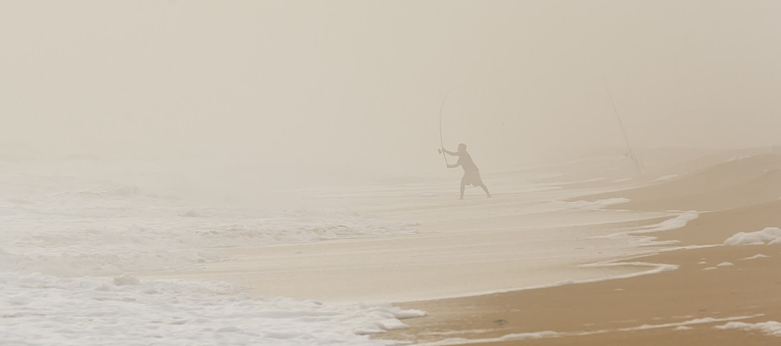 "Surf fisherman in the fog" stock image