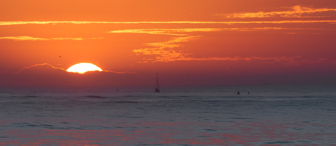 "Sailboat at dawn" stock image