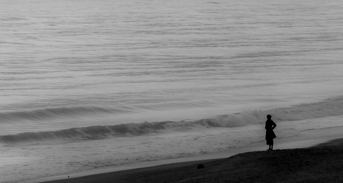 "Woman looking out over the beach" stock image