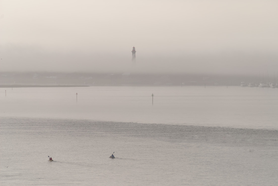 "Kayaks in the bay with lighthouse" stock image