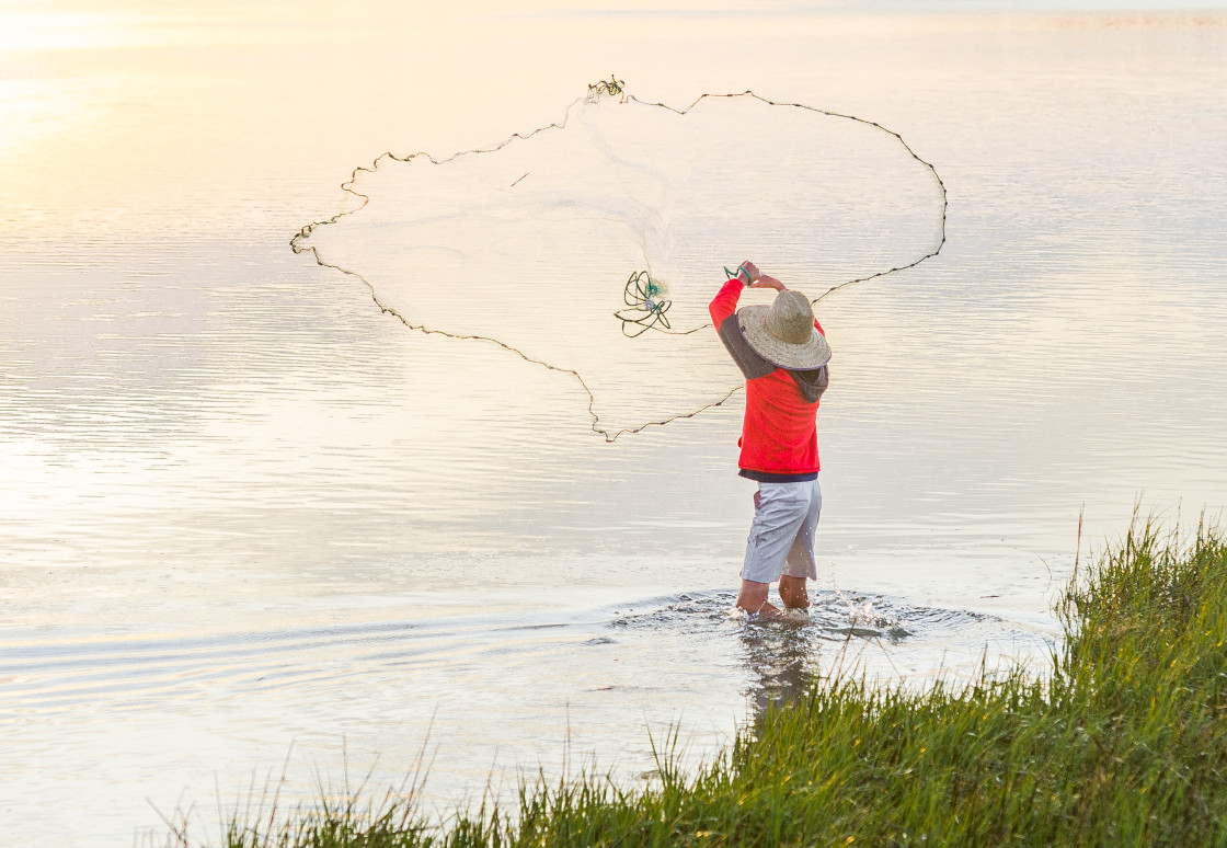 "Fisherman catching bait along the shore" stock image