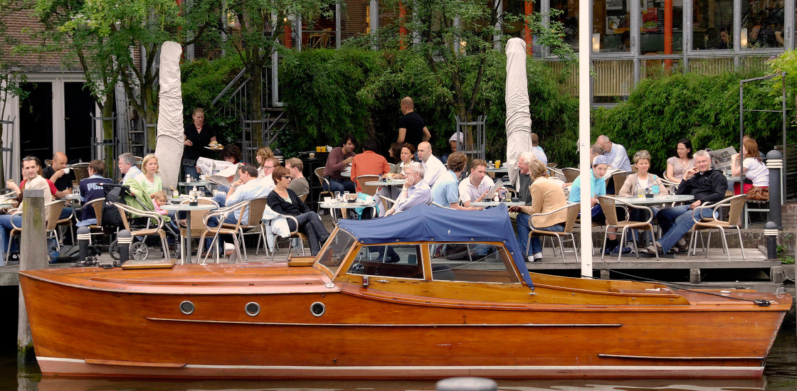 "Waterfront café and retro yacht in Amsterdam" stock image