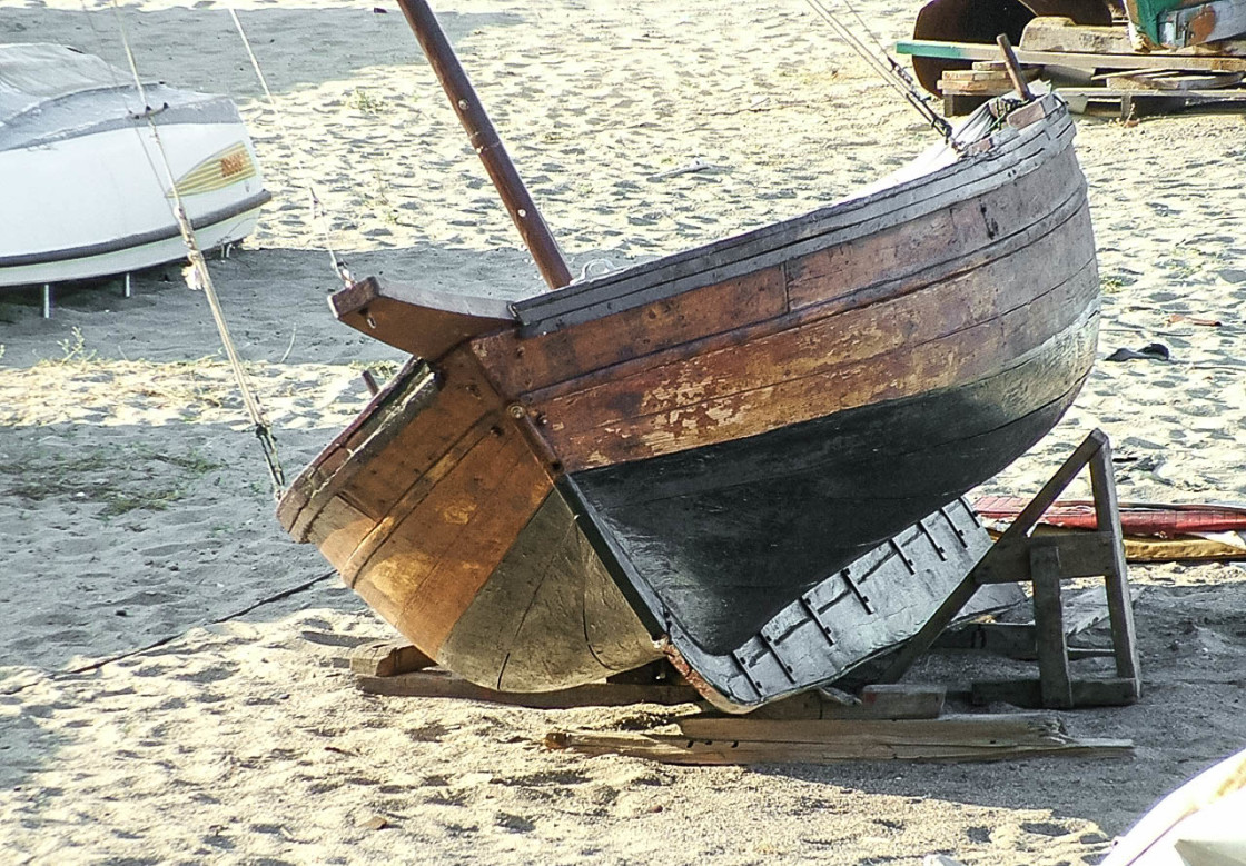 "Beached wooden sailboat" stock image