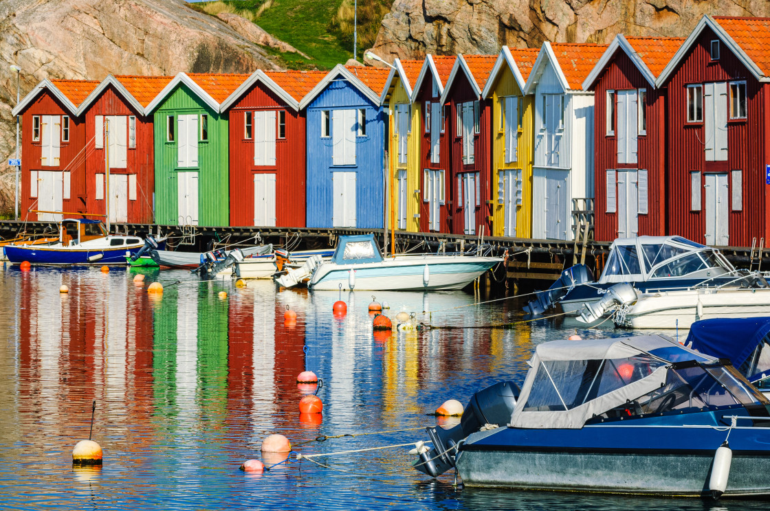 "Colorful fishing huts and boats moored in sea" stock image