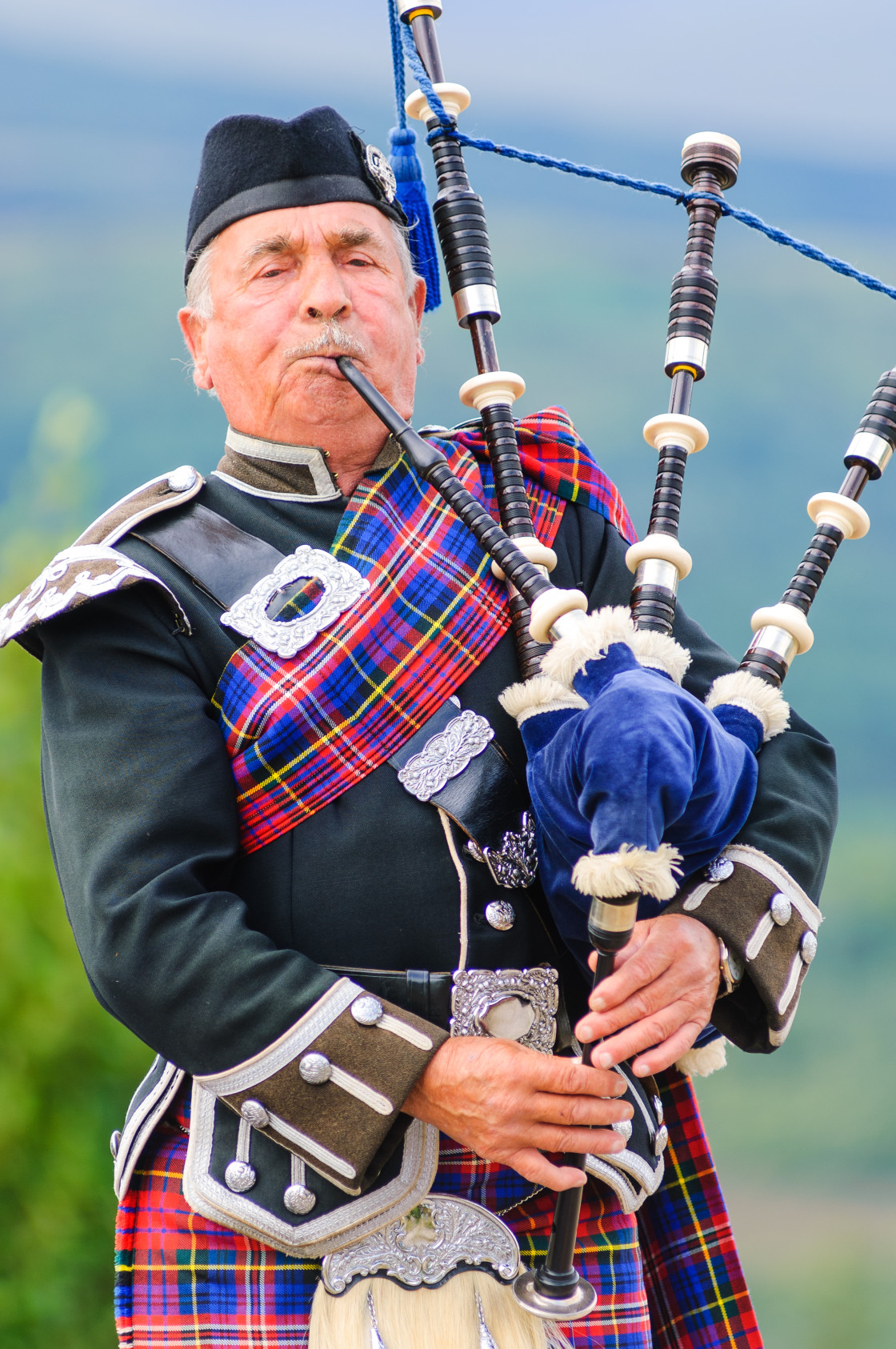 "Man playing bag pipes in traditional custome" stock image