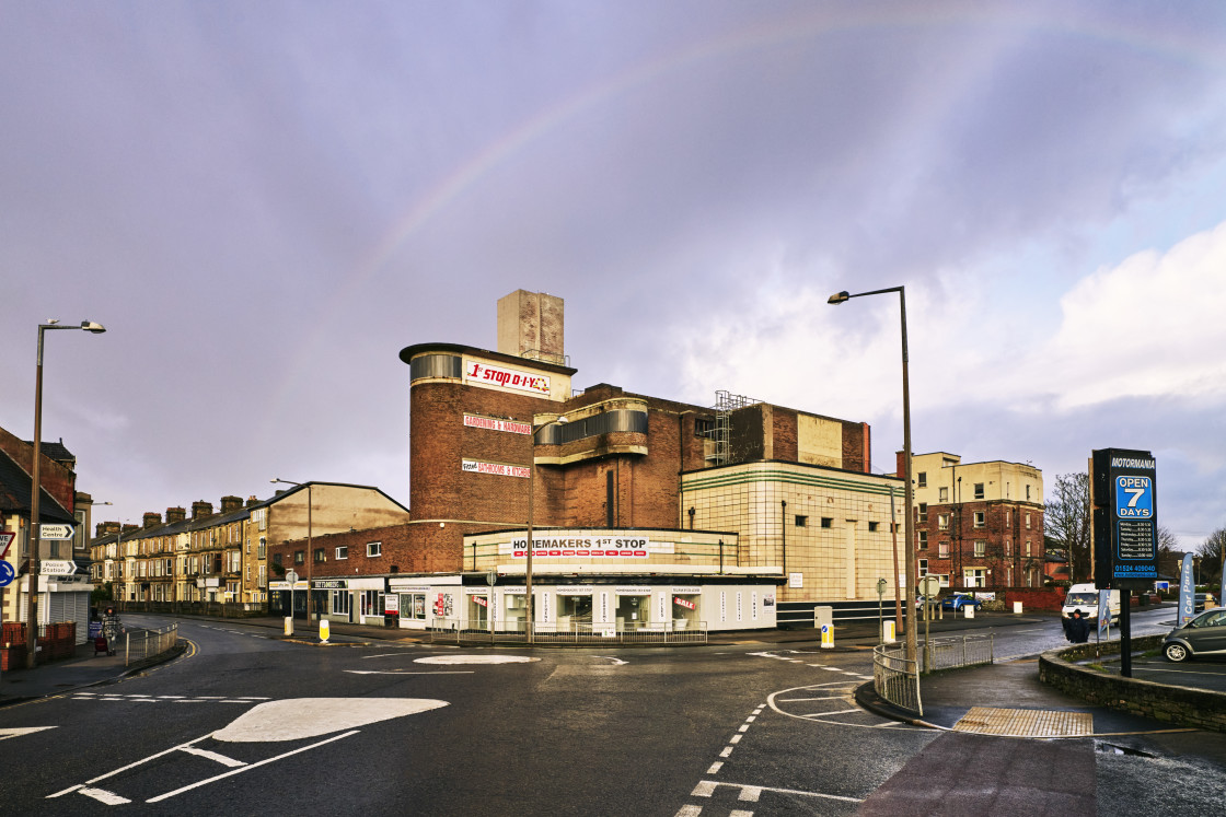 "A rainbow arched over the 1930s Odeon" stock image