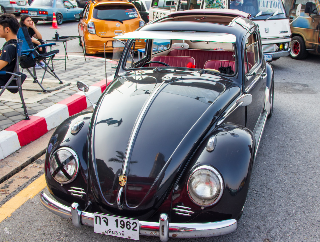 "an old, unusually designed VW Beetle with a Porsche trademark on the bonnet." stock image