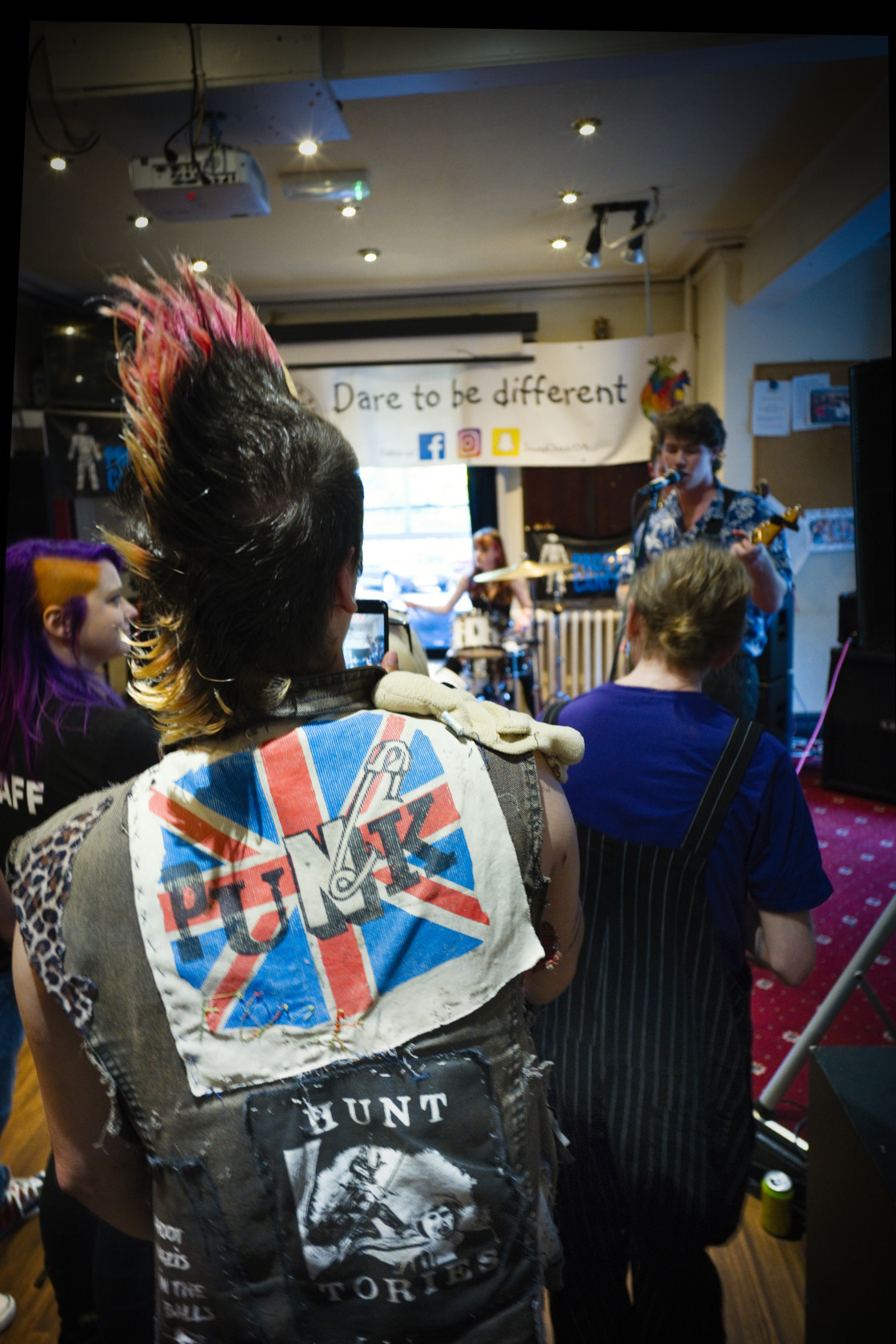 "Punk with Mohican hair watching a band" stock image