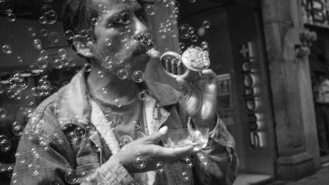 "Man blowing bubbles, Valle de Bravo, Mexico" stock image