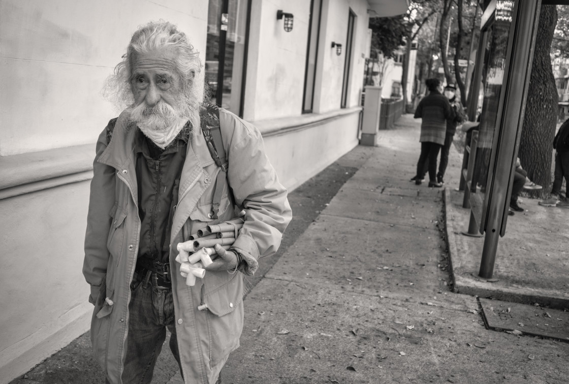 "old man walking with tubes for plumbinb, CDM" stock image