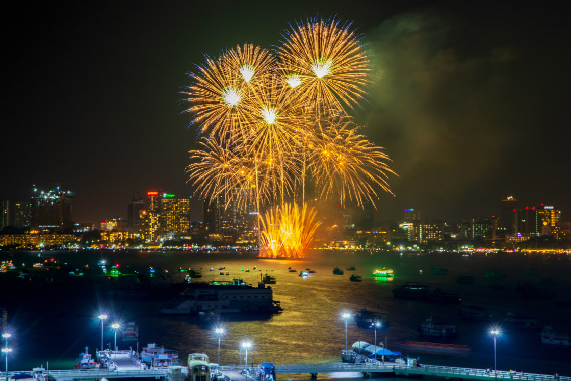 "fantastic and colorful fireworks display over the night sky of the city during a festival" stock image