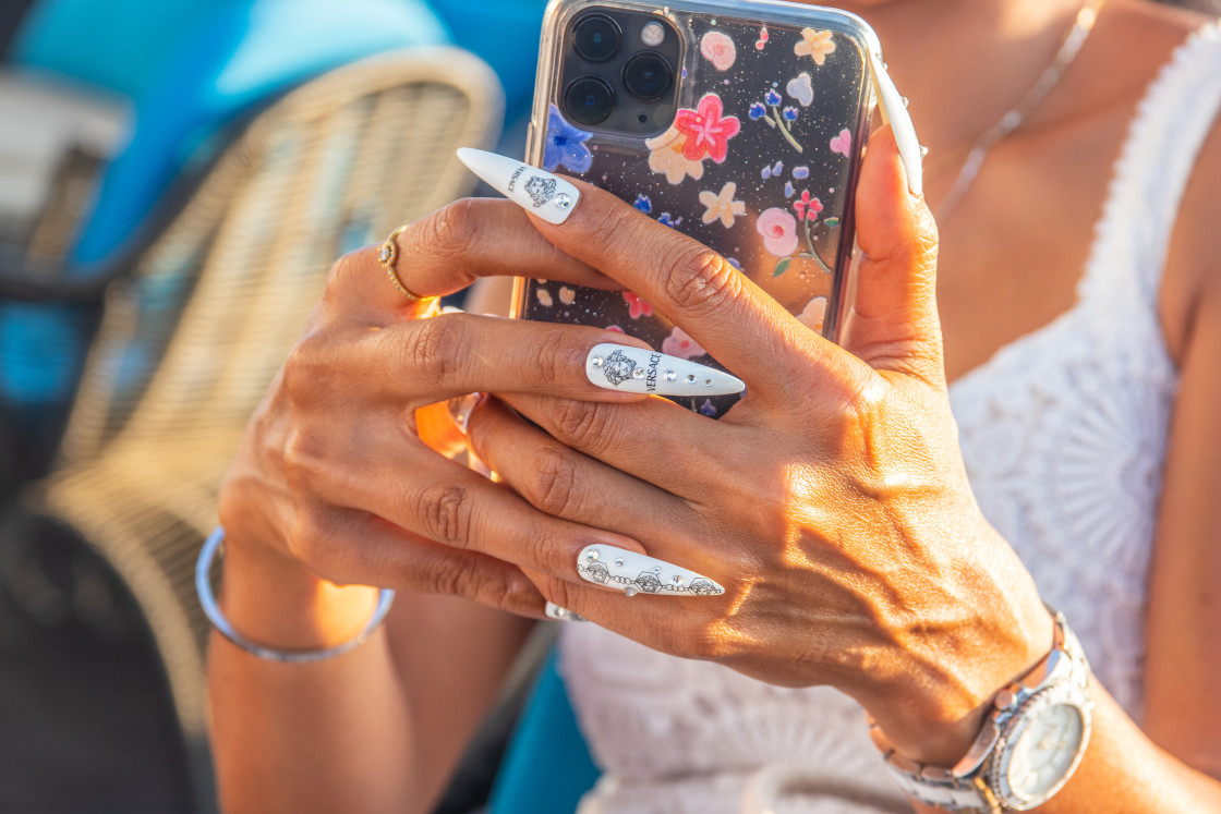 "A lady holds a stylish smartphone in her hand" stock image