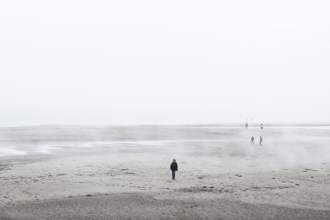 "Lone photographer walks towards camera" stock image