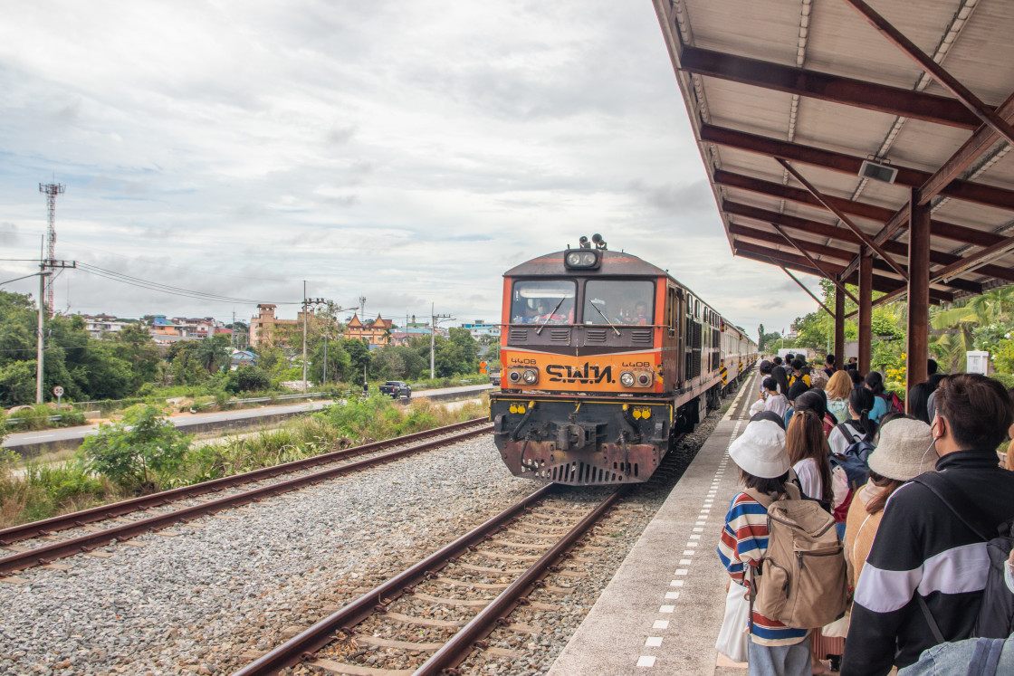 "People wait at a platform in Pattaya for the incoming train bound for Bangkok Thailand Asia" stock image